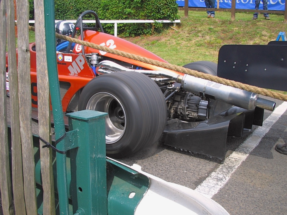 Photo of a race car spinning his rear wheels